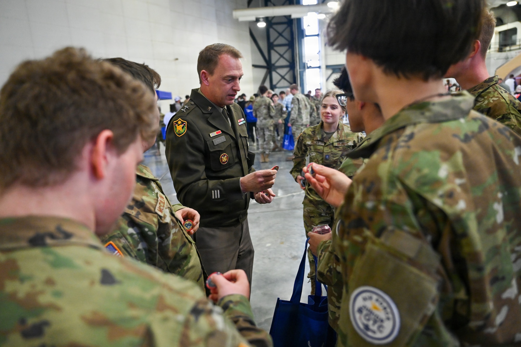 Major General Craig Strong, The Adjutant General for the Nebraska National Guard, presents a challenge coin to area Junior ROTC students during the 155th Air Refueling Wing’s Open Hangar, April 1, 2026, at the Nebraska National Guard air base in Lincoln, Nebraska. The event connected nearly 500 students with Guardmen to provide insight into career and education benefits available through the Air National Guard. (U.S. Air National Guard photo by Tech. Sgt. Phil Cowen)