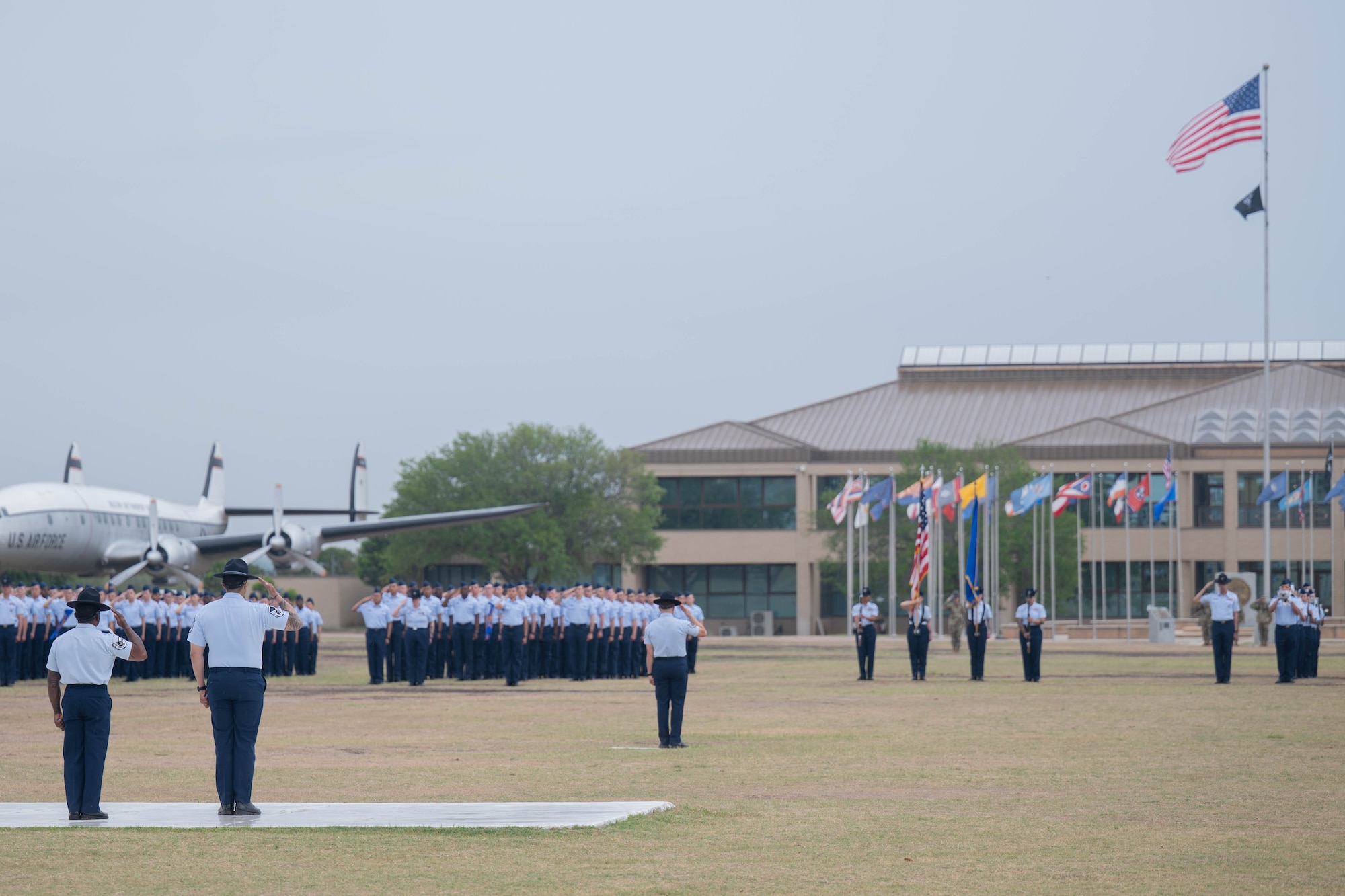 U.S. Air Force military training instructors assigned to the 37th Training Wing, salute the flag during the Basic Military Training graduation parade at Joint Base San Antonio-Lackland, Texas, April 2, 2026. The parade is the final of three graduation events, marking the new Airmen’s transition into the next phase of their Air Force careers. (U.S. Air Force photo by Airman 1st Class Emma Wright)