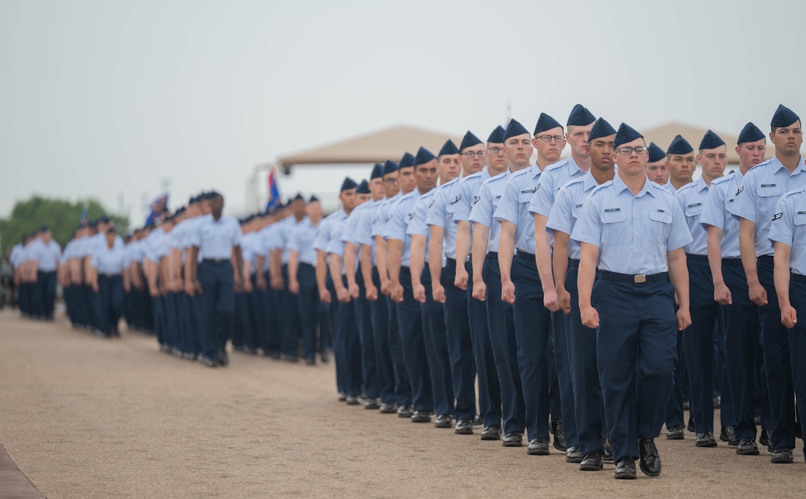U.S. Air Force Basic Military Training graduates march in flight formation down the ‘bomb run’ during the pass in review at Joint Base San Antonio-Lackland, Texas, April 2, 2026. The parade gives newly minted Airmen the opportunity to demonstrate drill proficiency, discipline and unit cohesion. (U.S. Air Force photo by Airman 1st Class Emma Wright)