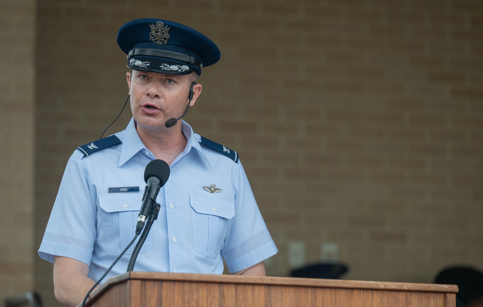 U.S. Air Force Col. Richard Kind, 97th Air Mobility Wing commander, addresses the graduates during the Basic Military Training graduation parade at Joint Base San Antonio-Lackland, Texas, April 2, 2026. Kind served as the reviewing official and led the graduates in the oath of enlistment. (U.S. Air Force photo by Airman 1st Class Emma Wright)
