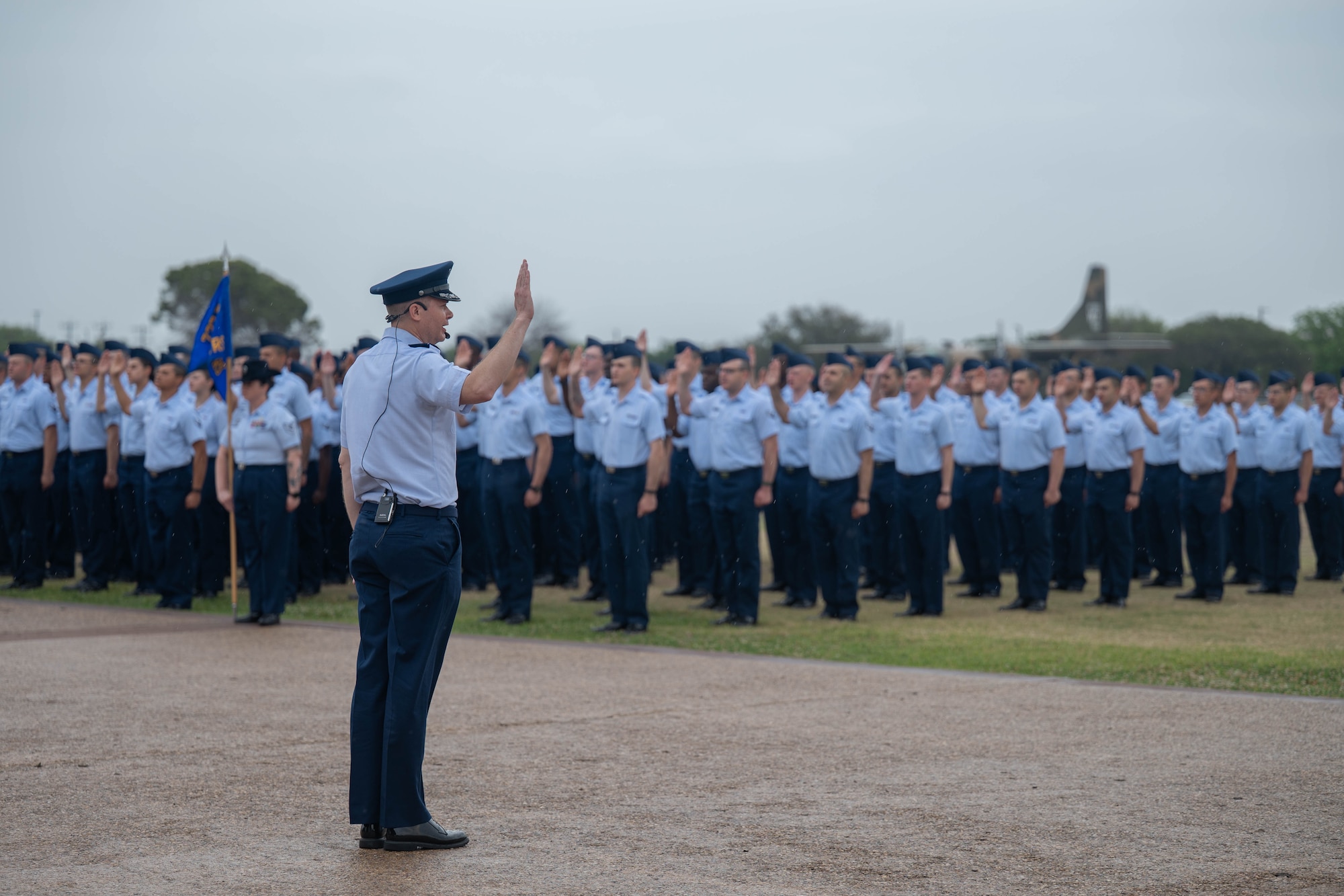U.S. Air Force Col. Richard Kind, 97th Air Mobility Wing commander, leads the graduates in the oath of enlistment during the Basic Military Training graduation parade at Joint Base San Antonio-Lackland, Texas, April 2, 2026. The oath of enlistment is the final portion of the Basic Military Training graduation parade. (U.S. Air Force photo by Airman 1st Class Emma Wright)