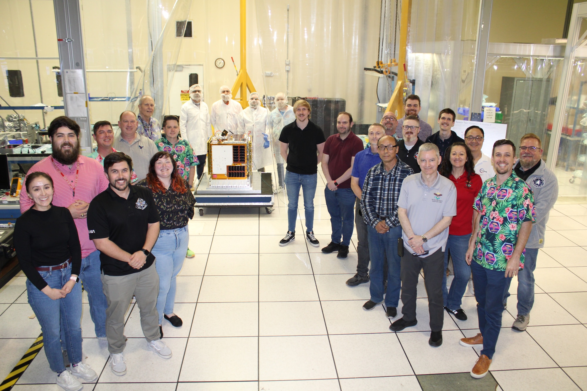 On February 25, 2026, the Department of War Space Test Program Satellite 7 team poses with the satellite ahead of delivery, integration, and launch on S29A. STPSat-7 hosts payloads from the Air Force Research Laboratory, Naval Research Laboratory, and Naval Information Warfare Center- Pacific, and academia. (U.S. Space Force photo by DoW STP)