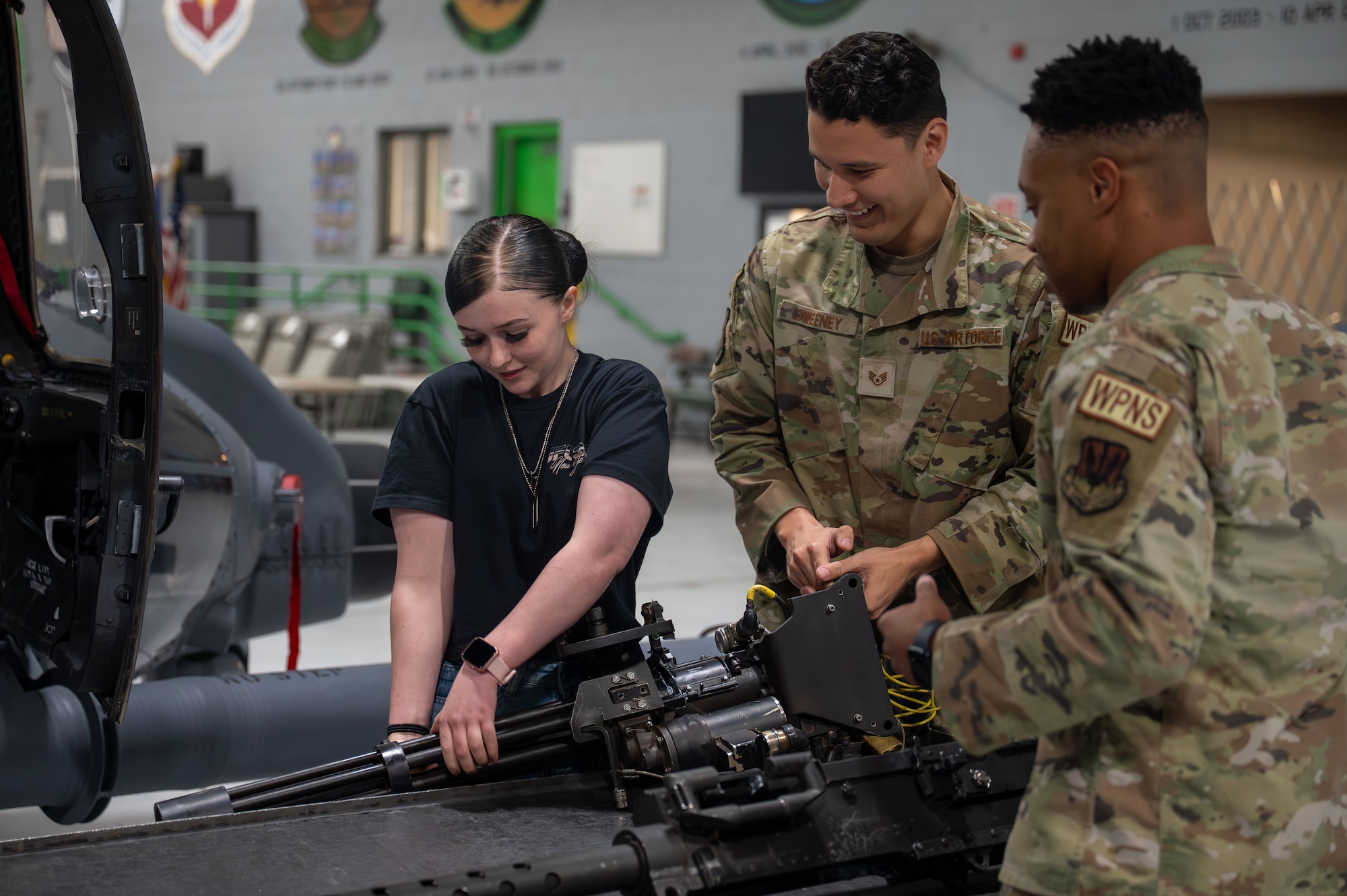 Airmen explain helicopter mounted weapons to foster teen