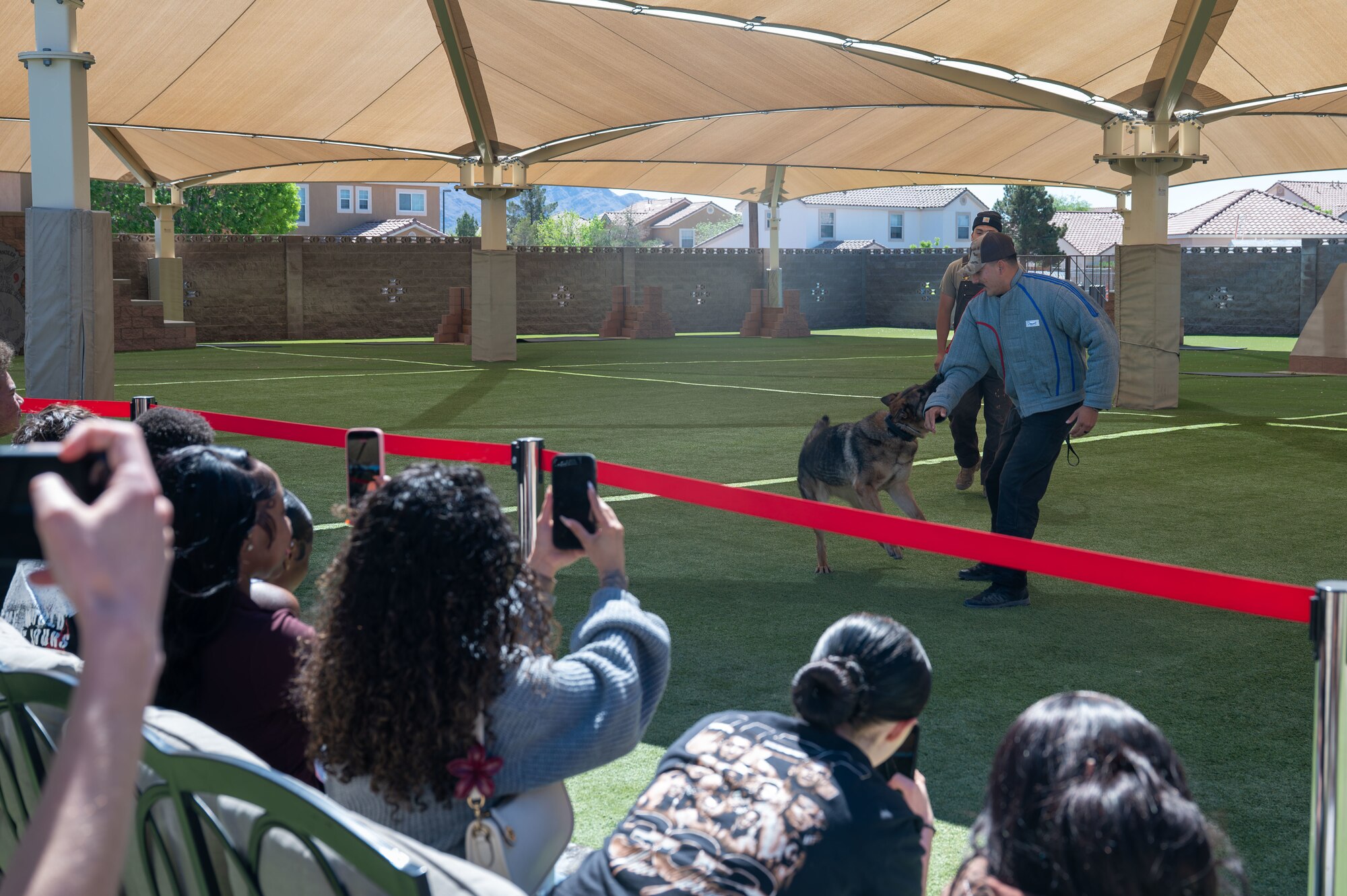 Military working dog handler demonstrates assisted K-9 capture for foster kids.