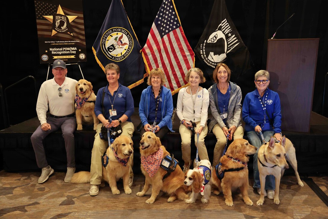 Members of Love on a Leash, a therapy dog organization that provides certified therapy dogs for veterans and others in need, pose for a photo during the Defense POW/MIA Accounting Agency Family Member Update in San Diego, Ca. , March 28, 2026.