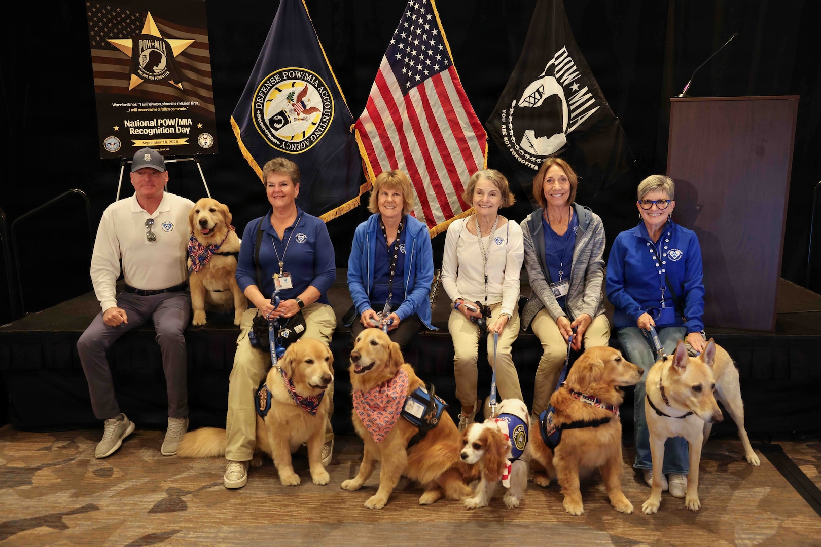 Members of Love on a Leash, a therapy dog organization that provides certified therapy dogs for veterans and others in need, pose for a photo during the Defense POW/MIA Accounting Agency Family Member Update in San Diego, Ca. , March 28, 2026.