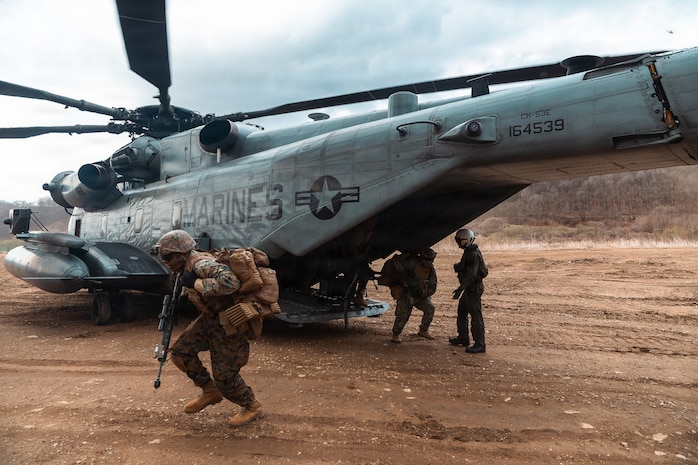 U.S. Marines assigned to 12th Littoral Combat Team, 12th Marine Littoral Regiment, 3rd Marine Division exit a CH-53E Super Stallion helicopter assigned to Marine Heavy Helicopter Squadron 466, Marine Aircraft Group 36, 1st Marine Aircraft Wing during an air assault as part of Korean Marine Exchange Program 26.1 in Gyeonggi-do, South Korea, March 31, 2026.