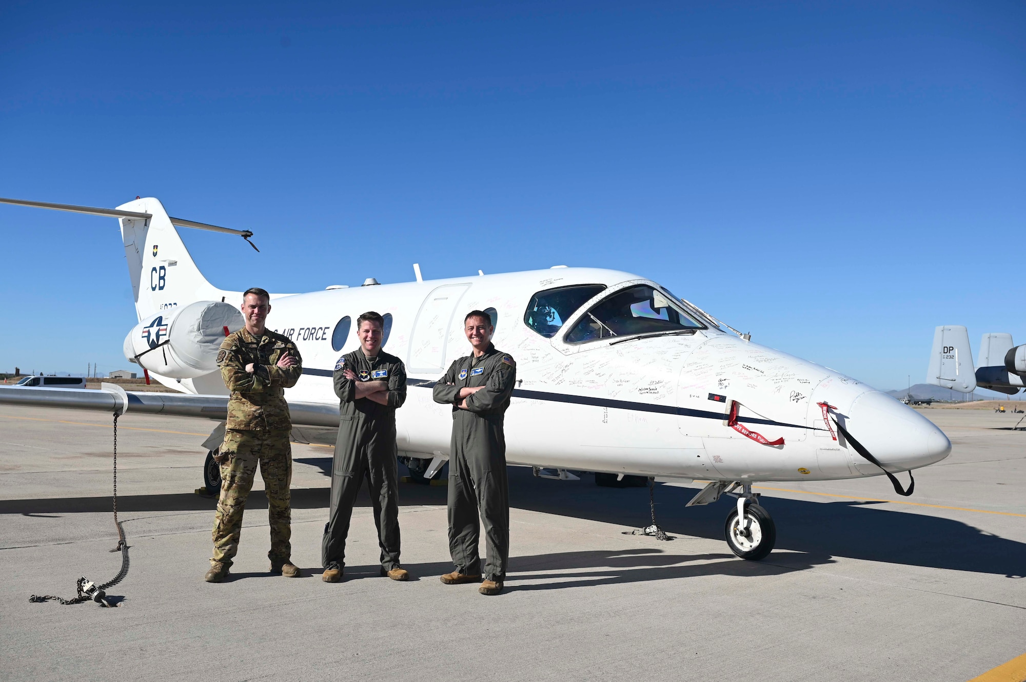 From left, Lt. Col. Richard Madden, 48th Flying Training Squadron deputy commander, Col. James J. Blech, 14th Flying Training Wing commander, Lt. Col Eddie Altizer, 48th Flying Training Squadron commander, standing in front of a T-1A Jayhawk at the 309th Aerospace Maintenance and Regeneration Group, commonly known as the "boneyard," on Davis-Monthan Air Force Base, Arizona, March 25, 2026.