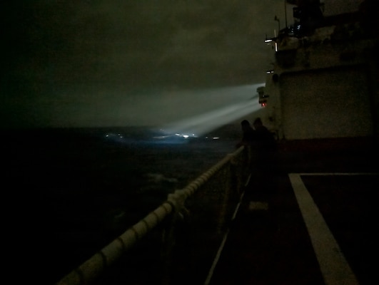 Bridge watchstanders aboard the Legend-class cutter USCGC Midgett (WMSL 757) locate a 23-foot single-outboard skiff vessel carrying three members of a missing family in the waters of Chuuk State, Federated States of Micronesia, during the early hours of April 6, 2026. The crew of Midgett rescued the family after the vessel went missing on March 30 in the waters of Chuuk State. (U.S. Coast Guard photo by Seaman Lauren Taber)