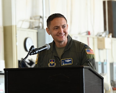 Lt. Col. Eddie Altizer, 48th Flying Training Squadron commander, gives final remarks during the T-1A Jayhawk retirement ceremony in the T-1 maintenance hangar at Columbus Air Force Base, Miss., March 25, 2026.