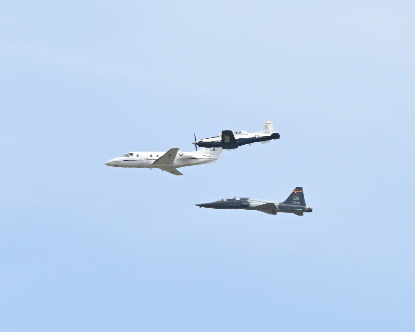 From top, a T-6 Texan II, T-1A Jayhawk, and T-38 Talon fly in formation over Columbus Air Force Base, Miss., March 24, 2026. The heritage formation was flown to honor the legacy of the T-1A Jayhawk as the airframe prepares for retirement after 30 years of service.