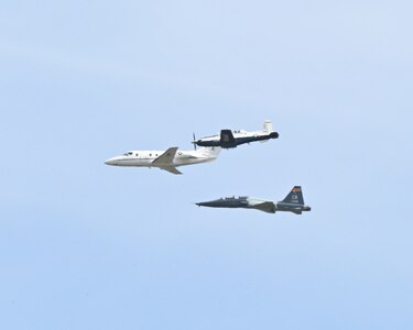From top, a T-6 Texan II, T-1A Jayhawk, and T-38 Talon fly in formation over Columbus Air Force Base, Miss., March 24, 2026. The heritage formation was flown to honor the legacy of the T-1A Jayhawk as the airframe prepares for retirement after 30 years of service.