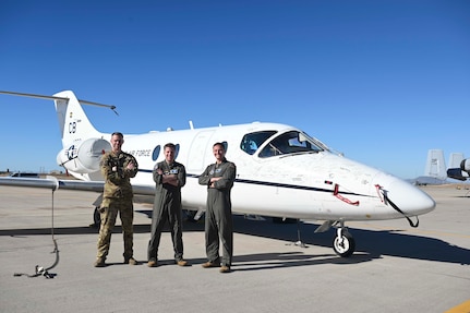 From left, Lt. Col. Richard Madden, 48th Flying Training Squadron deputy commander, Col. James J. Blech, 14th Flying Training Wing commander, Lt. Col Eddie Altizer, 48th Flying Training Squadron commander, standing in front of a T-1A Jayhawk at the 309th Aerospace Maintenance and Regeneration Group, commonly known as the "boneyard," on Davis-Monthan Air Force Base, Arizona, March 25, 2026.