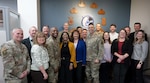 Maj. Gen. Thomas Sherman, Air Force Installation and Mission Support Center commander, and Chief Master Sgt. Ronnie Woods, AFIMSC command chief, pose for a group photo with the AFIMSC Detachment 6 team at Wright-Patterson Air Force Base, Ohio, April 6, 2026. The leaders visited the detachment to meet with the team and recognize personnel for their outstanding mission contributions. (U.S. Air Force photo by Brian Dietrick)
