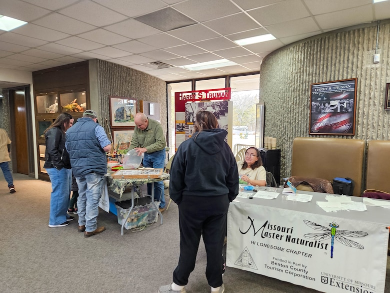 People checking out booth.