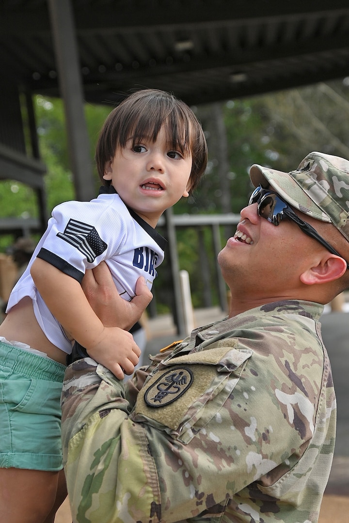Soldier holding his son.