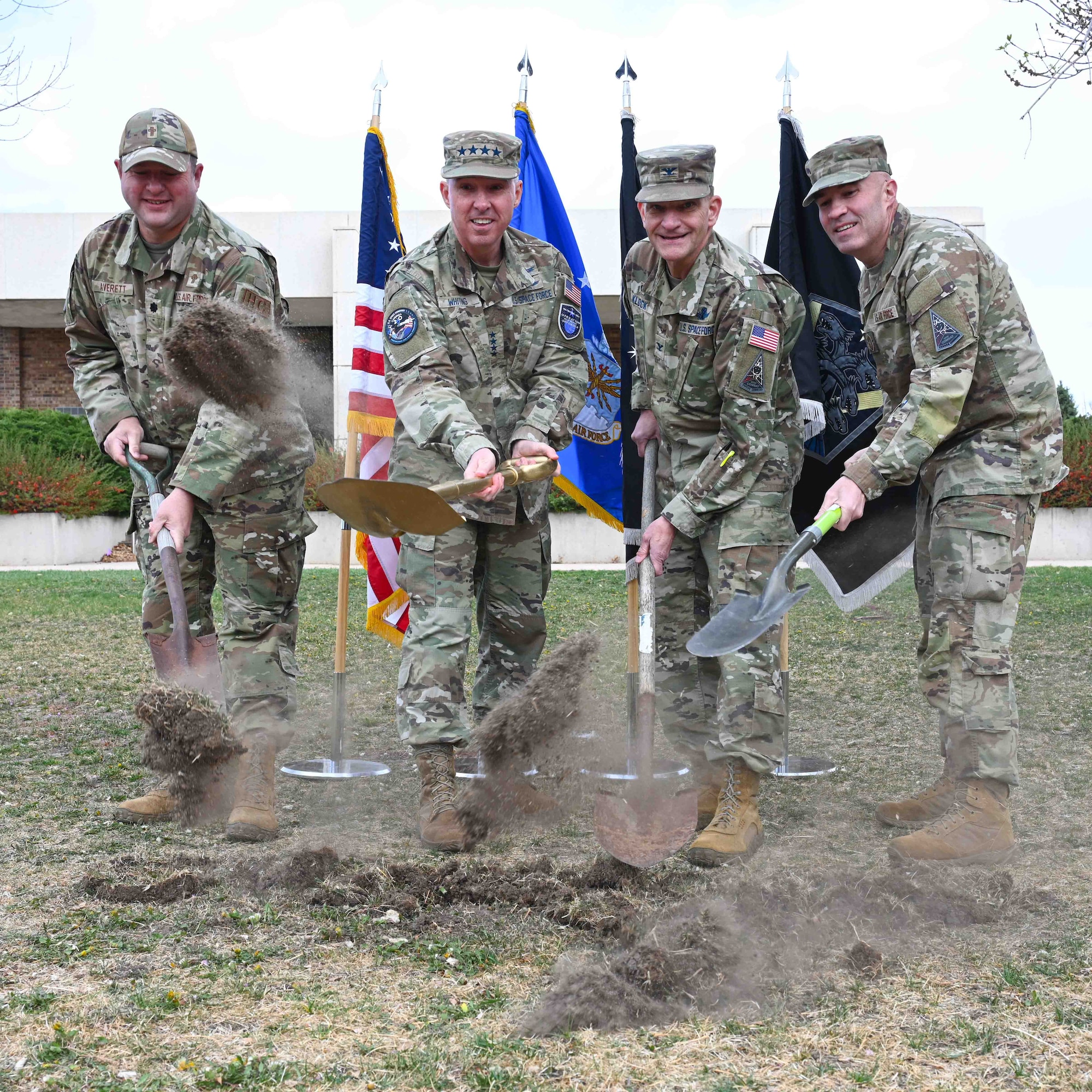 U.S. Air Force Lt. Col. Kip Averett, Space Base Delta 1 delta chaplain, U.S. Space Force Gen. Stephen Whiting, U.S. Space Command commander, USSF Col. Kenneth Klock, SBD 1 commander, and USAF Chief Master Sgt. Joseph Joslin, SBD 1 senior enlisted Airman, stand next to each other while they break ground.