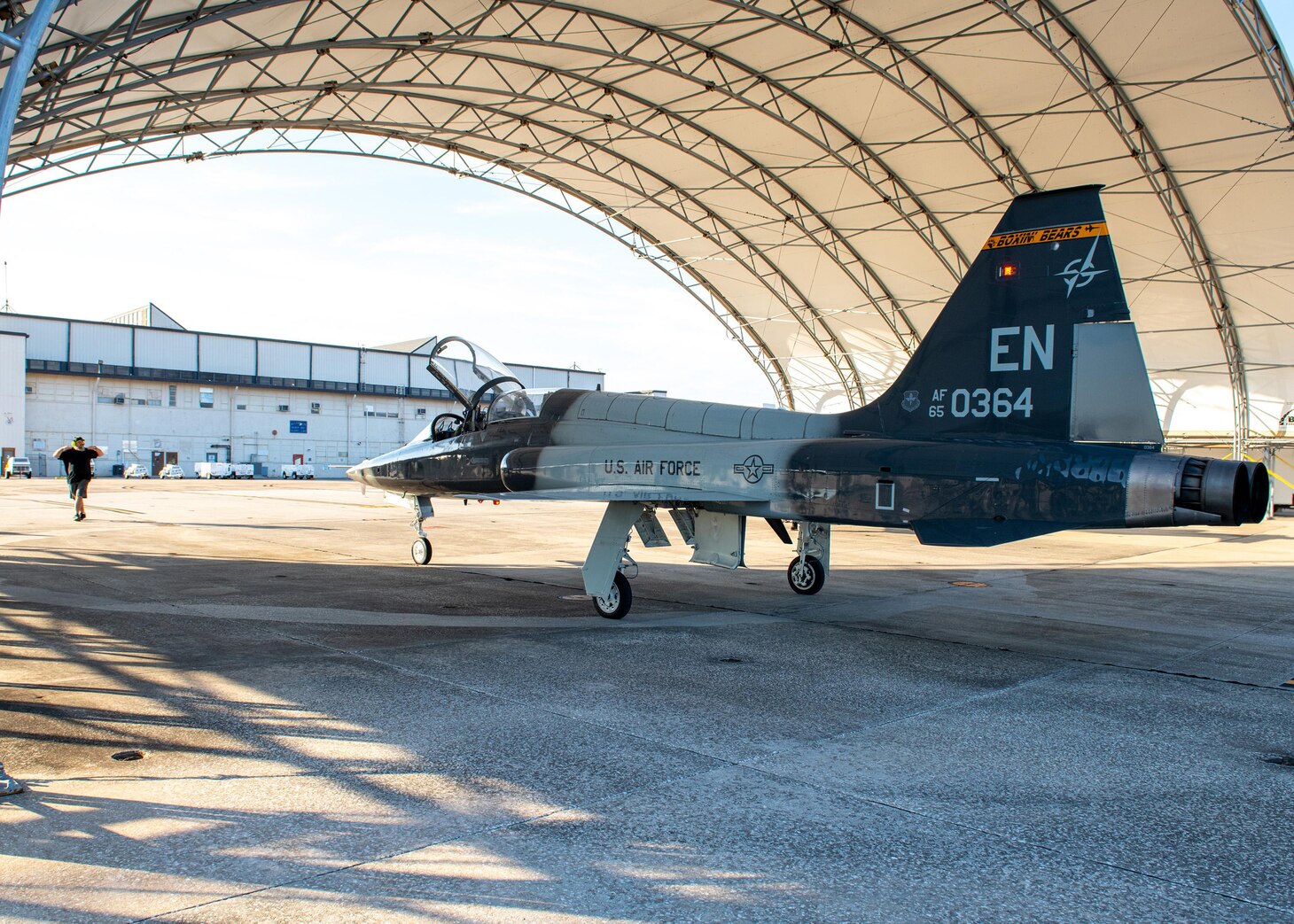 An Air Force T-38 Talon taxis to an aircraft shelter at  Fleet Readiness Center Southeast (FRCSE). This is FRCSE’s first T-38, which will undergo overhaul and repair as part of the Talon Repair, Inspection and Maintenance program (TRIM).