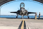 A Royal Navy (RN) F-35 Lightning II pilot debarks the aircraft after arriving at Fleet Readiness Center Southeast (FRCSE). The fifth-generation fighter is one of three aircraft from the RN that will undergo a Production Asset Inspection Requirement Tier II (PAIR II) corrosion-mitigation inspection at FRCSE.