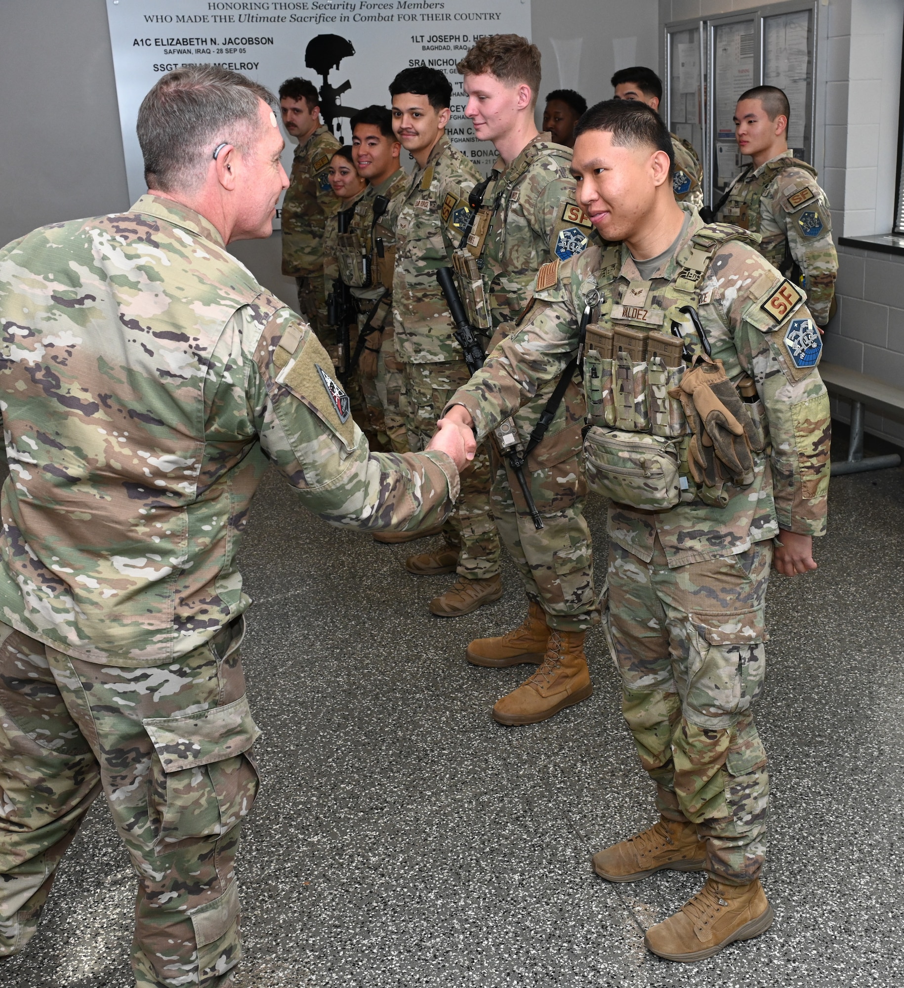 U.S. Space Force Lt. Gen. Gregory J. Gagnon shakes hands with Senoir Airman Joseph Valdez.