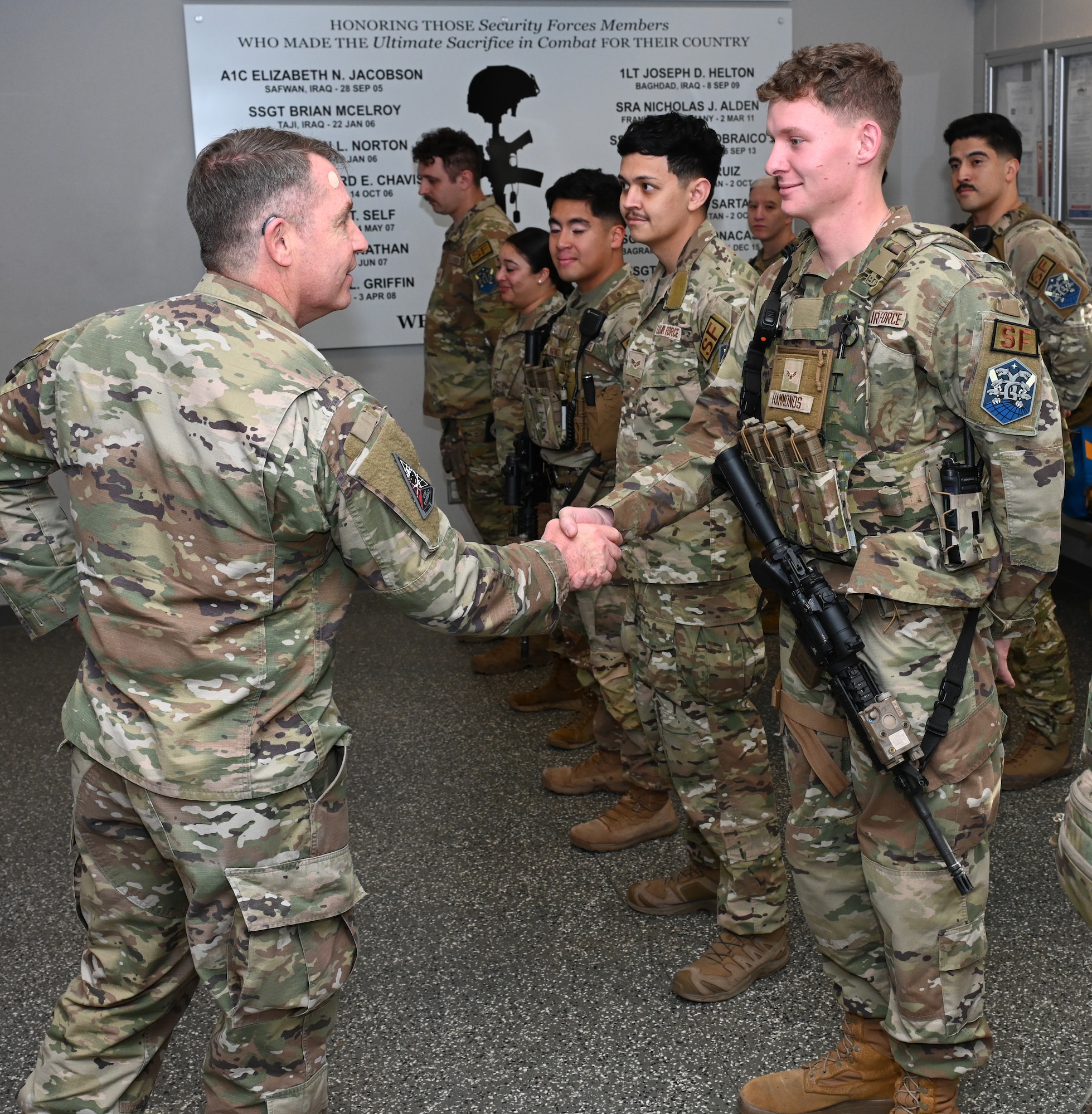 U.S. Space Force Lt. Gen. Gregory J. Gagnon shakes hands with U.S. Air Force Airman 1st Class Joshua Hammonds.