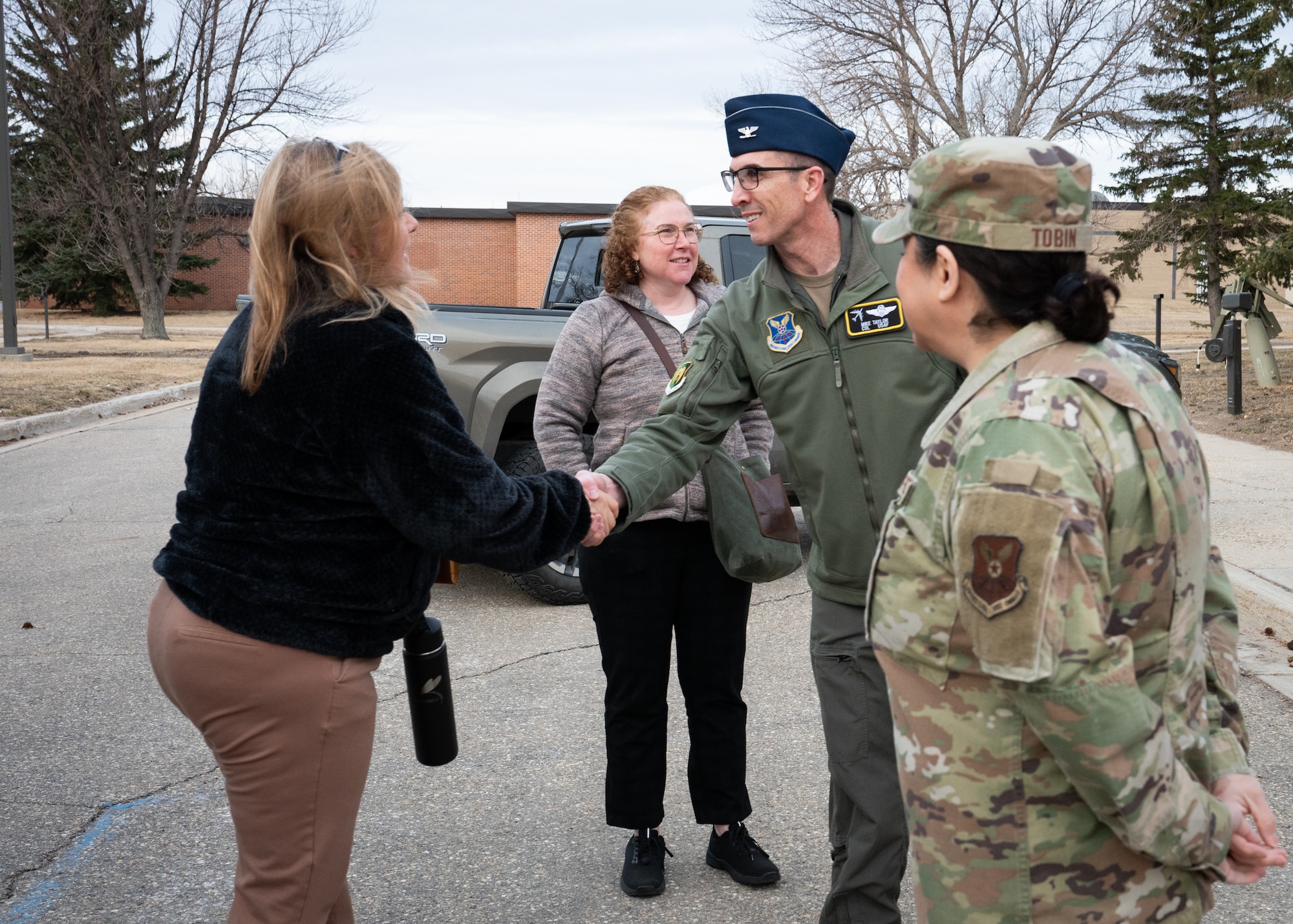 House Armed Services Committee staff members are greeted by U.S. Air Force Col. Thomas Taylor.