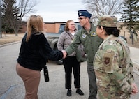 House Armed Services Committee staff members are greeted by U.S. Air Force Col. Thomas Taylor.
