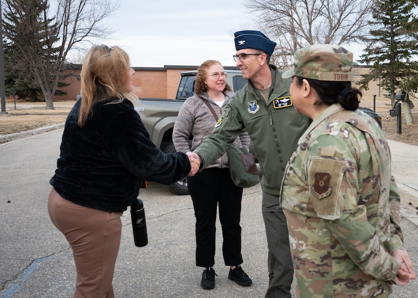 House Armed Services Committee staff members are greeted by U.S. Air Force Col. Thomas Taylor.