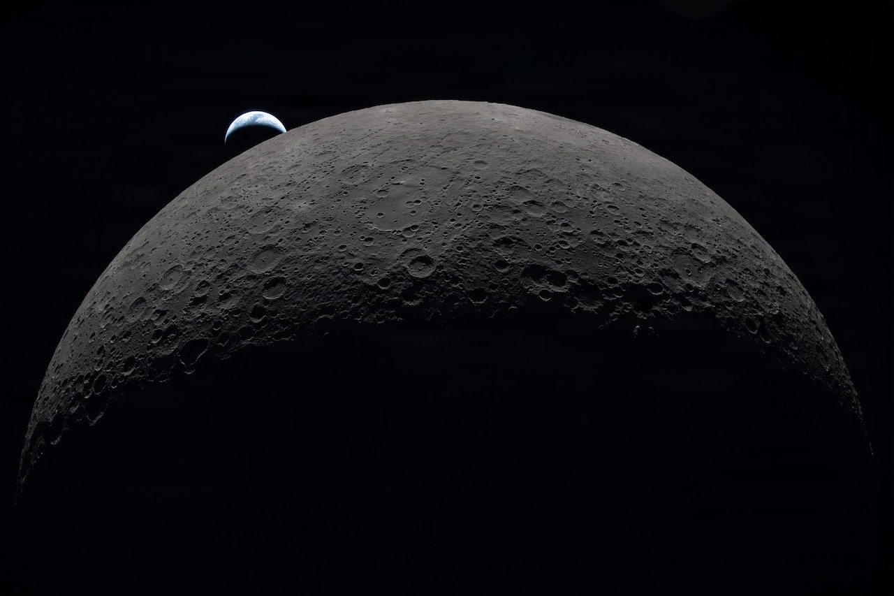 A close-up of the moon with the Earth in the background.