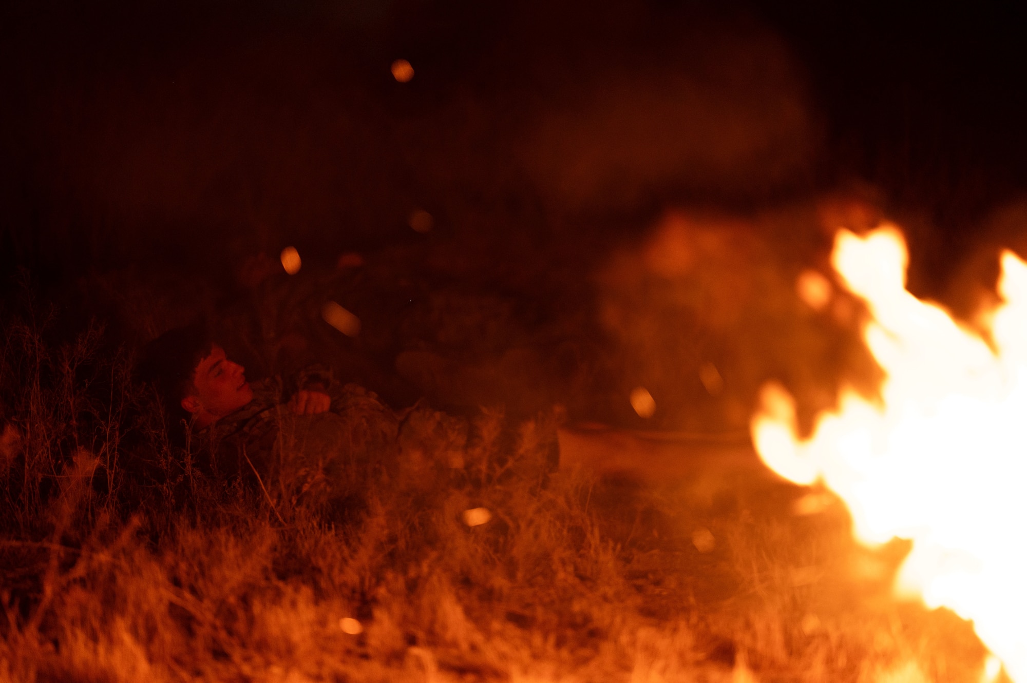 A simulated casualty calls for help during a training exercise at Davis-Monthan Air Force Base, Arizona, April 3, 2026. The Combat Leader Course uses realistic, high-pressure scenarios to prepare Pararescuemen to respond decisively during rescue operations. (U.S. Air Force photo by Airman 1st Class Jaden Kidd)