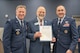 (from left to right) U.S. Air Force Col. Jimmy Schlabach, Mayor Mark Jantzer and U.S. Air Force Col. Jesse W. Lamarand pose for a photo with the signed  Month of the Military Child proclamation.