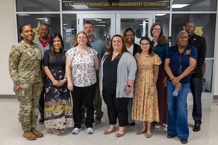 U.S. Army Financial Management Command Army Military Pay Office employees pose for a photo in front of USAFMCOM headquarters at the Maj. Gen. Emmett J. Bean Federal Center in Indianapolis after completing a reserve pay course, sponsored by the U.S. Army Reserve Center, and during a tour of USAFMCOM headquarters and the Defense Finance and Accounting Service March 20, 2026. Pictured from left to right are: Command Sgt. Maj. Joy L. Allen, USAFMCOM senior enlisted advisor; Ronald Houston, Military Pay Operations Readiness Division chief; Diana Stuart, MPO military pay technician from Fort Knox, Kentucky; Amy Randazzo, MPO military pay technician from USAFMCOM headquarters in Indianapolis; Michael Pavinich, MPO internal control technician from the U.S. Military Academy at West Point, New York; Kelly Delia, MPO military pay supervisor from Joint Base Langley-Eustis, Virgina; Kameisha Lundy, MPO military pay technician from Fort Gillem, Georgia; Jessalyn Golgart, MPO military pay technician from Fort Stewart, Georgia; Denise Gallion, USAFMCOM interim deputy to the commander; Kimberly Lawrence, MPO Sustainment and Training Division chief; and Gennaro Penn, MPO director. (U.S. Army photo by Mark R. W. Orders-Woempner)
