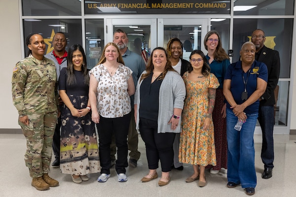 U.S. Army Financial Management Command Army Military Pay Office employees pose for a photo in front of USAFMCOM headquarters at the Maj. Gen. Emmett J. Bean Federal Center in Indianapolis after completing a reserve pay course, sponsored by the U.S. Army Reserve Center, and during a tour of USAFMCOM headquarters and the Defense Finance and Accounting Service March 20, 2026. Pictured from left to right are: Command Sgt. Maj. Joy L. Allen, USAFMCOM senior enlisted advisor; Ronald Houston, Military Pay Operations Readiness Division chief; Diana Stuart, MPO military pay technician from Fort Knox, Kentucky; Amy Randazzo, MPO military pay technician from USAFMCOM headquarters in Indianapolis; Michael Pavinich, MPO internal control technician from the U.S. Military Academy at West Point, New York; Kelly Delia, MPO military pay supervisor from Joint Base Langley-Eustis, Virgina; Kameisha Lundy, MPO military pay technician from Fort Gillem, Georgia; Jessalyn Golgart, MPO military pay technician from Fort Stewart, Georgia; Denise Gallion, USAFMCOM interim deputy to the commander; Kimberly Lawrence, MPO Sustainment and Training Division chief; and Gennaro Penn, MPO director. (U.S. Army photo by Mark R. W. Orders-Woempner)