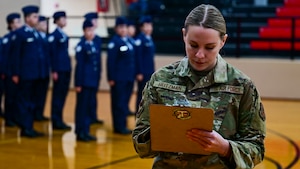 Master Sgt. Deana Heitzman grades one of the performances from an Air Force Junior Reserve Officer Training Corps junior varsity drill competition.
