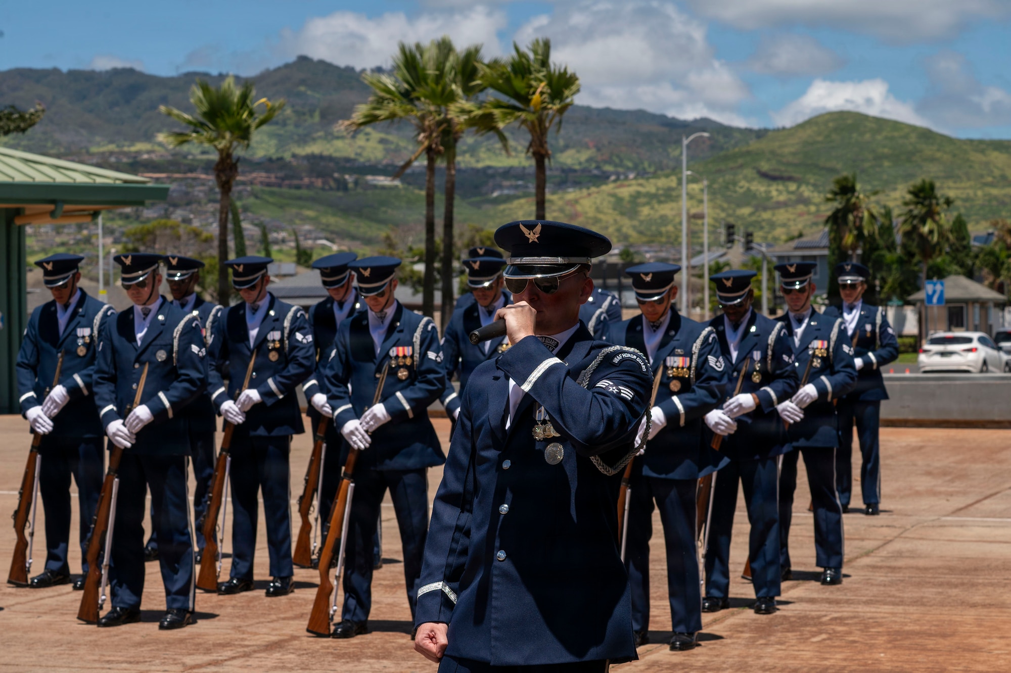 U.S. Air Force Senior Airman Zackery Easley, U.S. Air Force Honor Guard ceremonial guardsman, narrates a drill team performance at Kapolei High School, Kapolei, Hawaii, March 30, 2026. The team engaged with Kapolei’s U.S. Marine Corps Junior Reserve Officer Training Corps cadets over the weekend before performing for the entire high school. (U.S. Air Force photo by Staff Sgt. Jordan Powell)