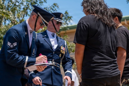 U.S. Air Force Senior Airman Aaron Miles signs an autograph for a student at Kapolei High School, Kapolei, Hawaii March 30, 2026. Miles spoke about his three years of drill team experience, including the opportunity to lead the team. (U.S. Air Force photo by Staff Sgt. Jordan Powell)