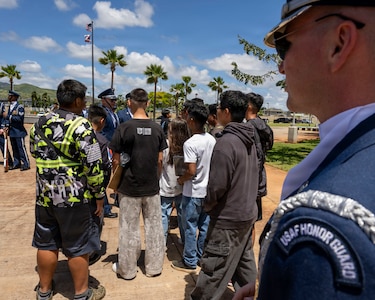 U.S. Air Force Senior Airman Aidan Coffey speaks to Kapolei High School Junior Reserve Officer Training Corps cadets in Kapolei, Hawaii, March 30, 2026. The cadets met Coffey at the Pacific Regional Drill Meet March 28 and ran to meet him again after the school performance. (U.S. Air Force photo by Staff Sgt. Jordan Powell)
