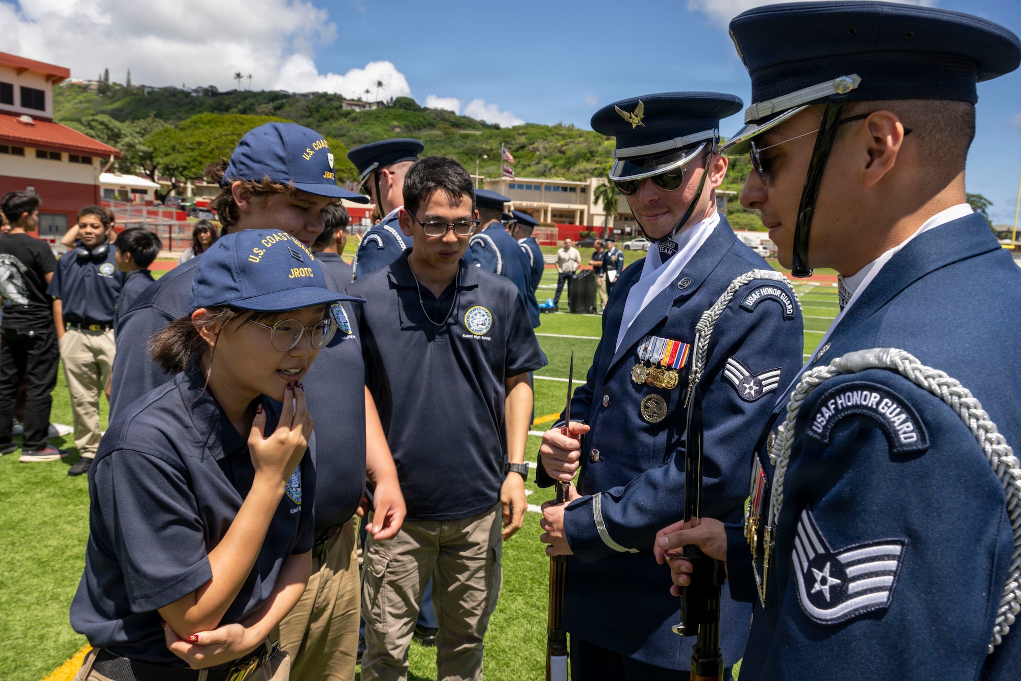 A Kalani Coast Guard Junior Reserve Officer Training Corps cadet asks U.S. Air Force Staff Sgt. Marco Amaro, noncommissioned officer in charge of the U.S. Air Force Honor Guard Drill Team’s Hawaii tour, a question about exhibition drill in Kalani, Hawaii, April 1, 2026. The Kalani JROTC is one of 16 Coast Guard JROTC programs in the nation and in its second year of operation. (U.S. Air Force photo by Staff Sgt. Jordan Powell)