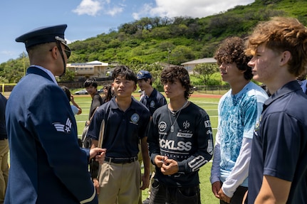 U.S. Air Force Senior Airman Wijeury Collado, U.S. Air Force Honor Guard ceremonial guardsman, answers questions following a performance in Kalani, Hawaii, April 1, 2026. U.S. Air Force Honor Guard Drill Team members personally engaged with students who approached them, sharing their experiences and opportunities in the Air Force. (U.S. Air Force photo by Staff Sgt. Jordan Powell)