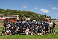 The U.S. Air Force Honor Guard Drill Team poses with Kalani High School Coast Guard Junior Reserve Officer Training Corps cadets in Kalani, Hawaii, April 1, 2026. The students asked questions about military service and the performance experiences of the drill team. (U.S. Air Force photo by Staff Sgt. Jordan Powell)