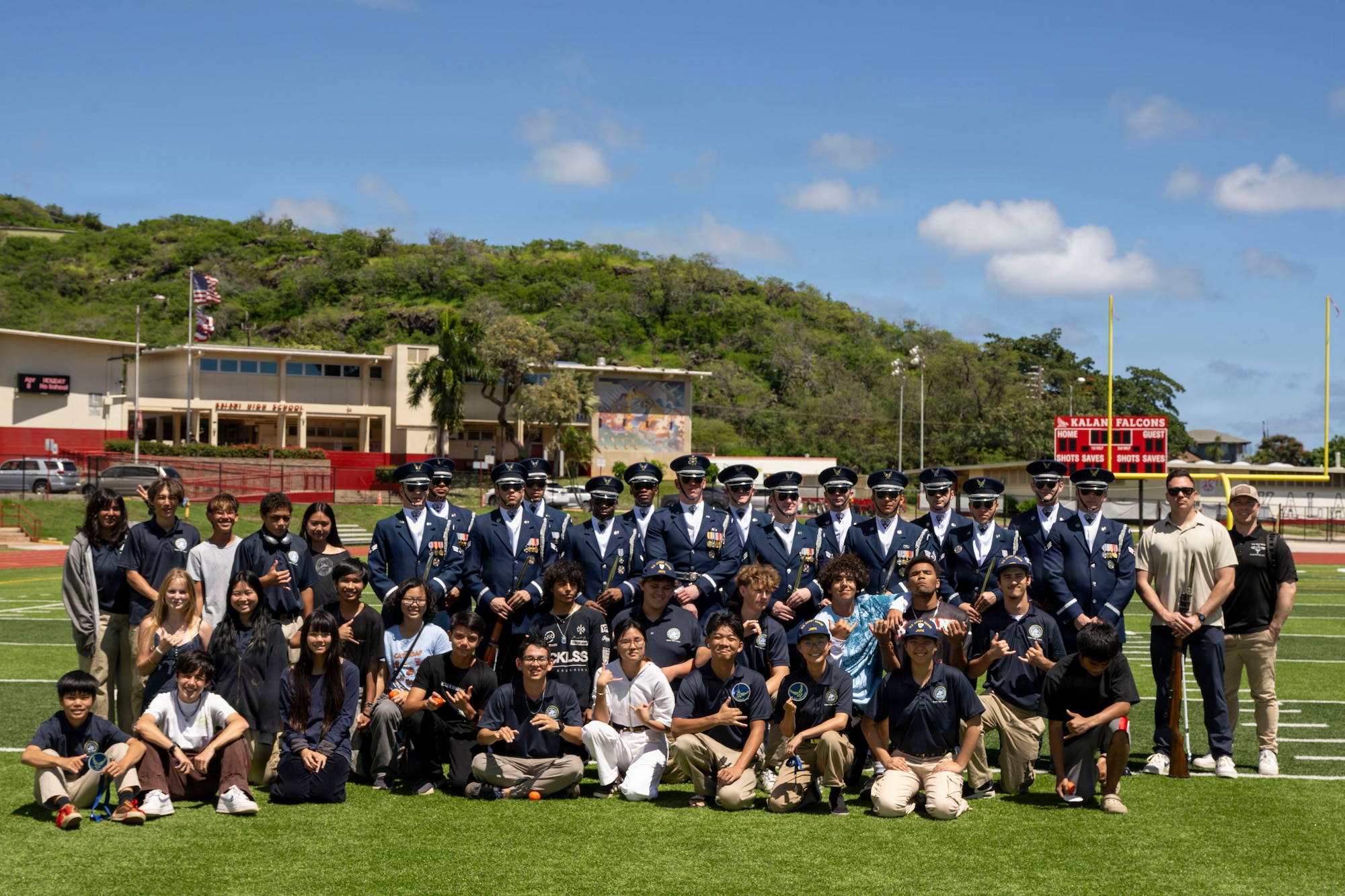 The U.S. Air Force Honor Guard Drill Team poses with Kalani High School Coast Guard Junior Reserve Officer Training Corps cadets in Kalani, Hawaii, April 1, 2026. The students asked questions about military service and the performance experiences of the drill team. (U.S. Air Force photo by Staff Sgt. Jordan Powell)