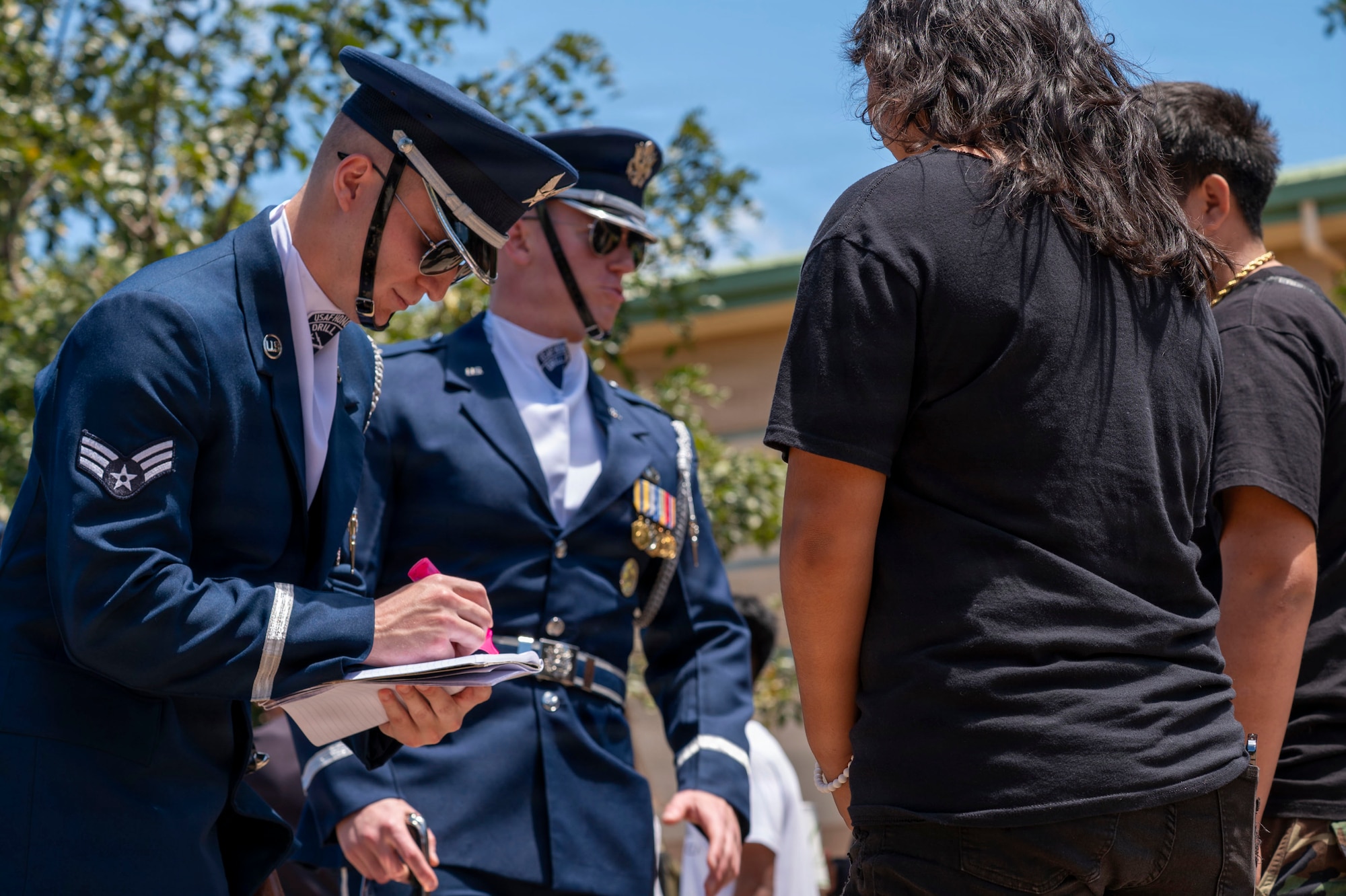 U.S. Air Force Senior Airman Aaron Miles signs an autograph for a student at Kapolei High School, Kapolei, Hawaii March 30, 2026. Miles spoke about his three years of drill team experience, including the opportunity to lead the team. (U.S. Air Force photo by Staff Sgt. Jordan Powell)