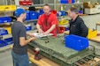 Photo of employees speaking with the aerospace auditor