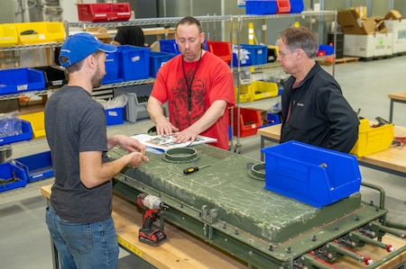 Photo of employees speaking with the aerospace auditor