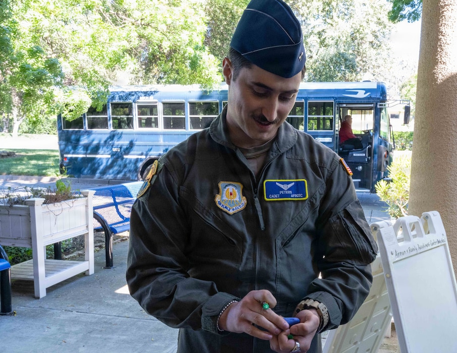 Cadet decorates a stone during a tour