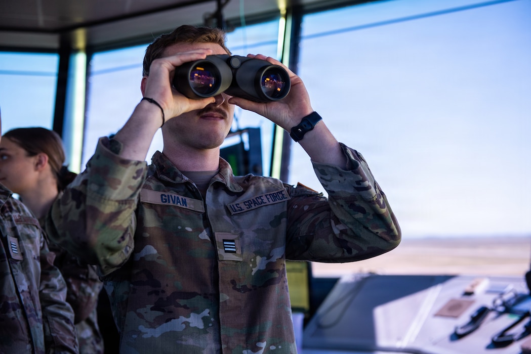 Cadet uses binoculars in air traffic control tower during tour