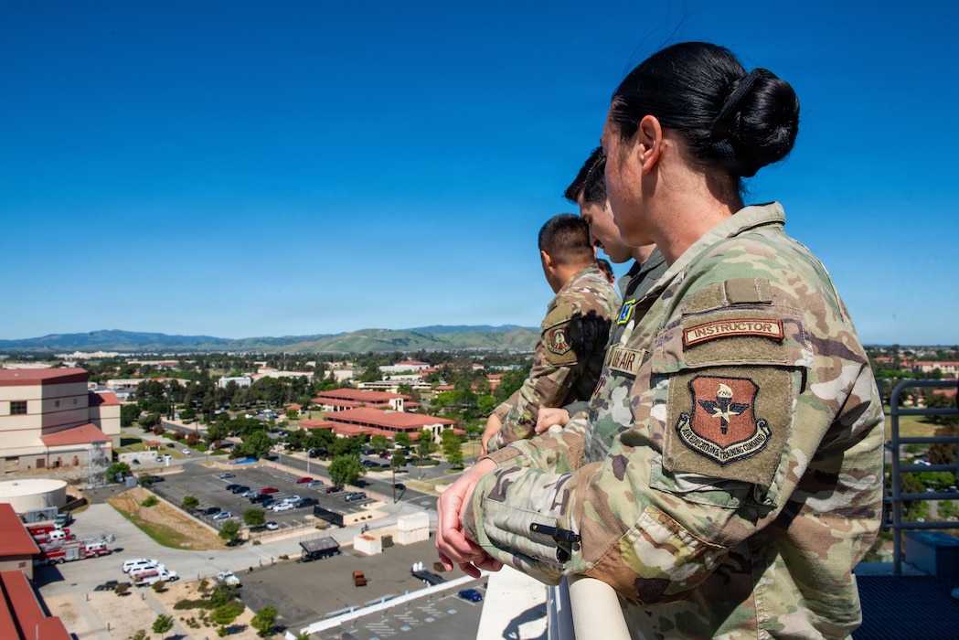 ROTC instructor and cadets view base from air traffic control tower