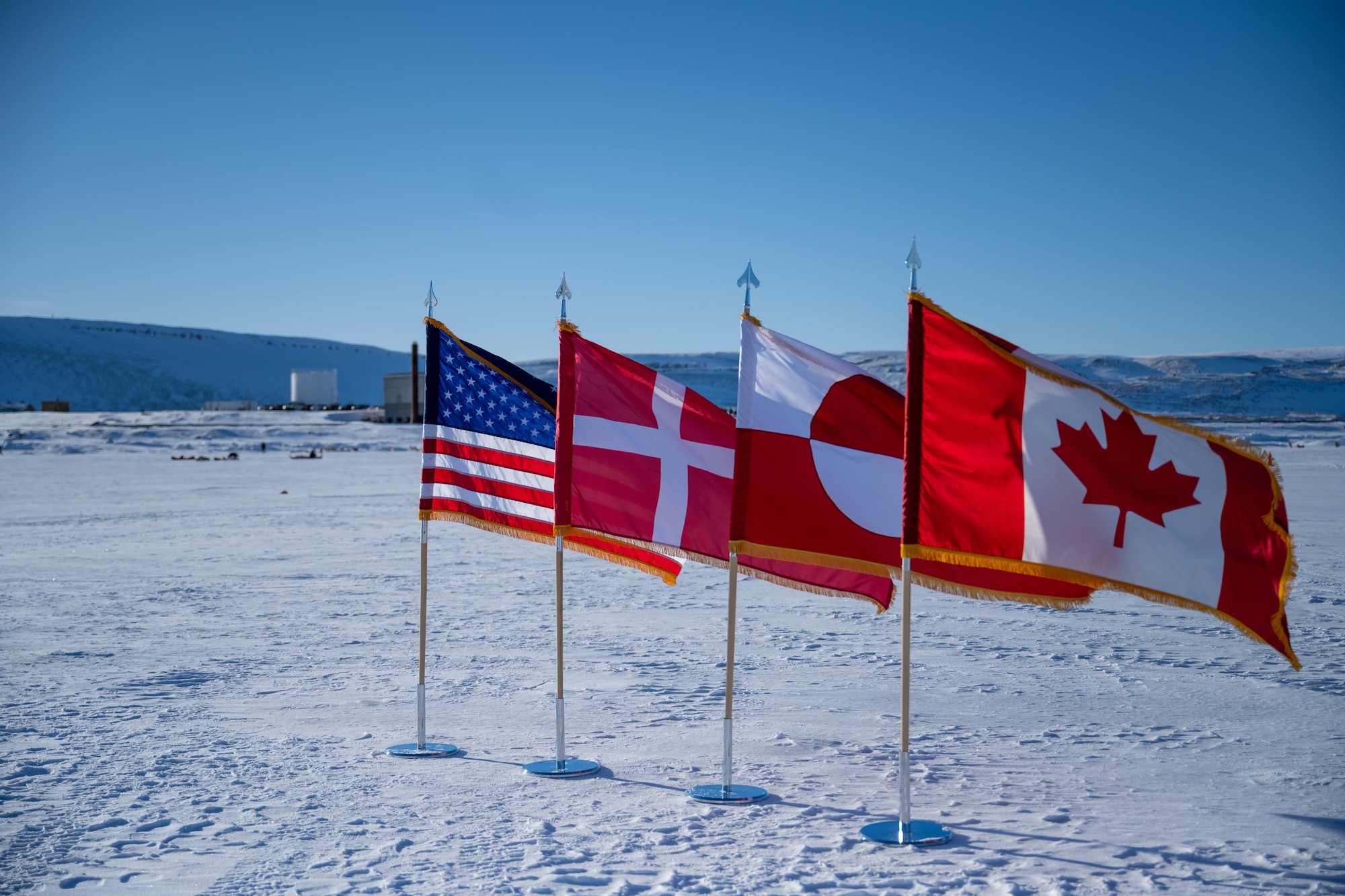 Flags of four nations are displayed during Greenlandic Heritage Week events