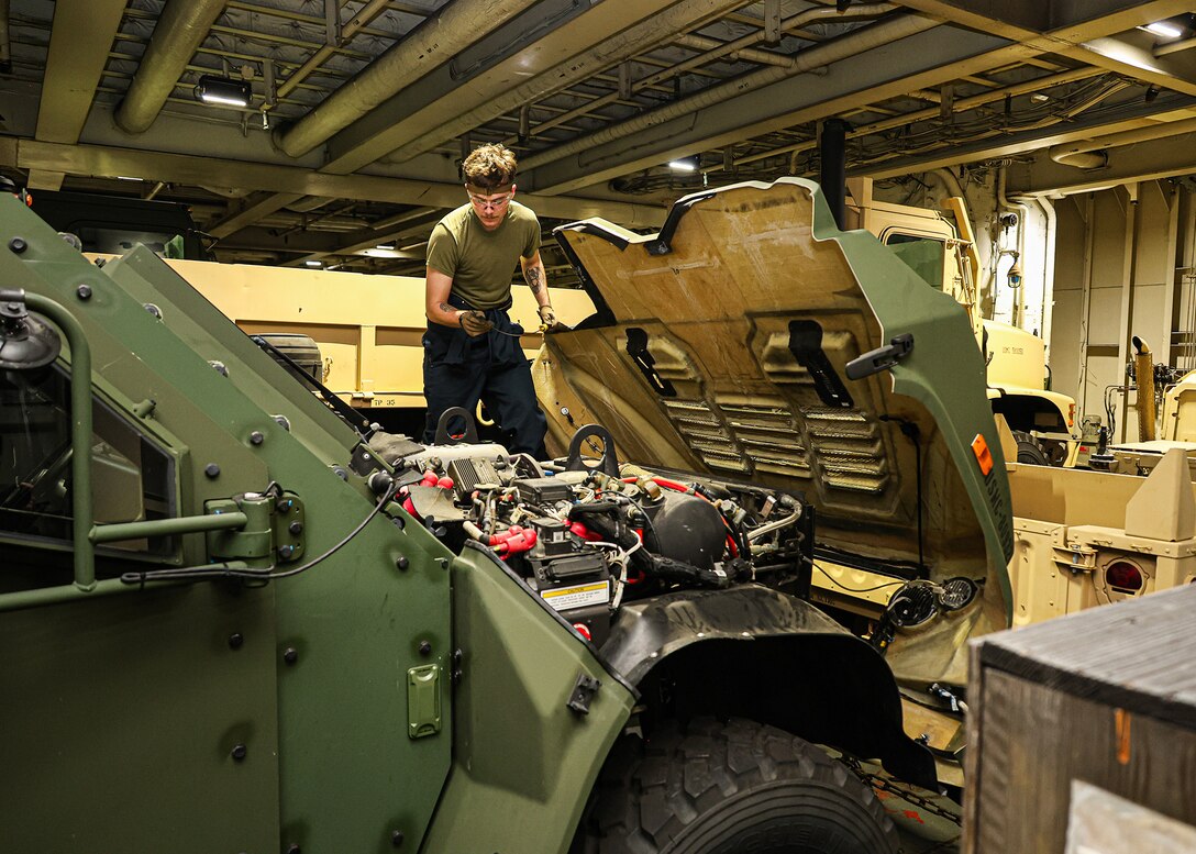 A U.S. Marine assigned to I Marine Expeditionary Force conducts pre-operation checks and services on a Joint Light Tactical Vehicle March 8, 2026, aboard the USNS Sgt. William W. Seay in the Philippine Sea. The checks and services were in preparation for a maritime prepositioning force offload at the Port of Cagayan de Oro, Philippines, in support of Exercise Balikatan 26. Balikatan is a longstanding annual exercise between the Armed Forces of the Philippines and U.S. military designed to strengthen the ironclad alliance, improve combined capabilities and demonstrate commitment to regional security and stability. (U.S. Marine Corps photo by Cpl. Nicholas Martinez)