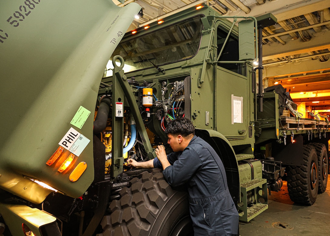 A U.S. Marine  assigned to I Marine Expeditionary Force conducts pre-operation checks and services on a Medium Tactical Vehicle Replacement March 8, 2026, aboard the USNS Sgt. William W. Seay in the Philippine Sea. The checks and services were in preparation for a maritime prepositioning force offload at the Port of Cagayan de Oro, Philippines, in support of Exercise Balikatan 26. Balikatan is a longstanding annual exercise between the Armed Forces of the Philippines and U.S. military designed to strengthen the ironclad alliance, improve combined capabilities and demonstrate commitment to regional security and stability. (U.S. Marine Corps photo by Cpl. Nicholas Martinez)